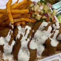 Falafel Over Rice Platter · Served with mixed salad and choice of fries or hummus.