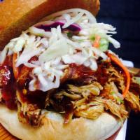 Pulled Chicken Sandwich · Coleslaw, onions, house pickles ,crispy chicken skin and BBQ sauce.