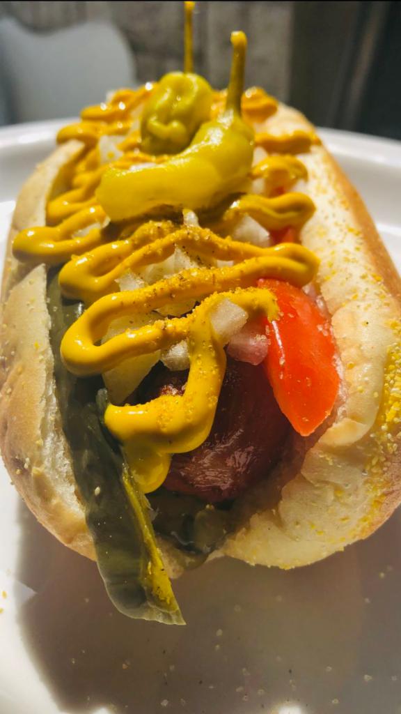 Chicago Style Dog · Hot peppers, mustard, relish, pickles, tomatoes, onions and celery salt.