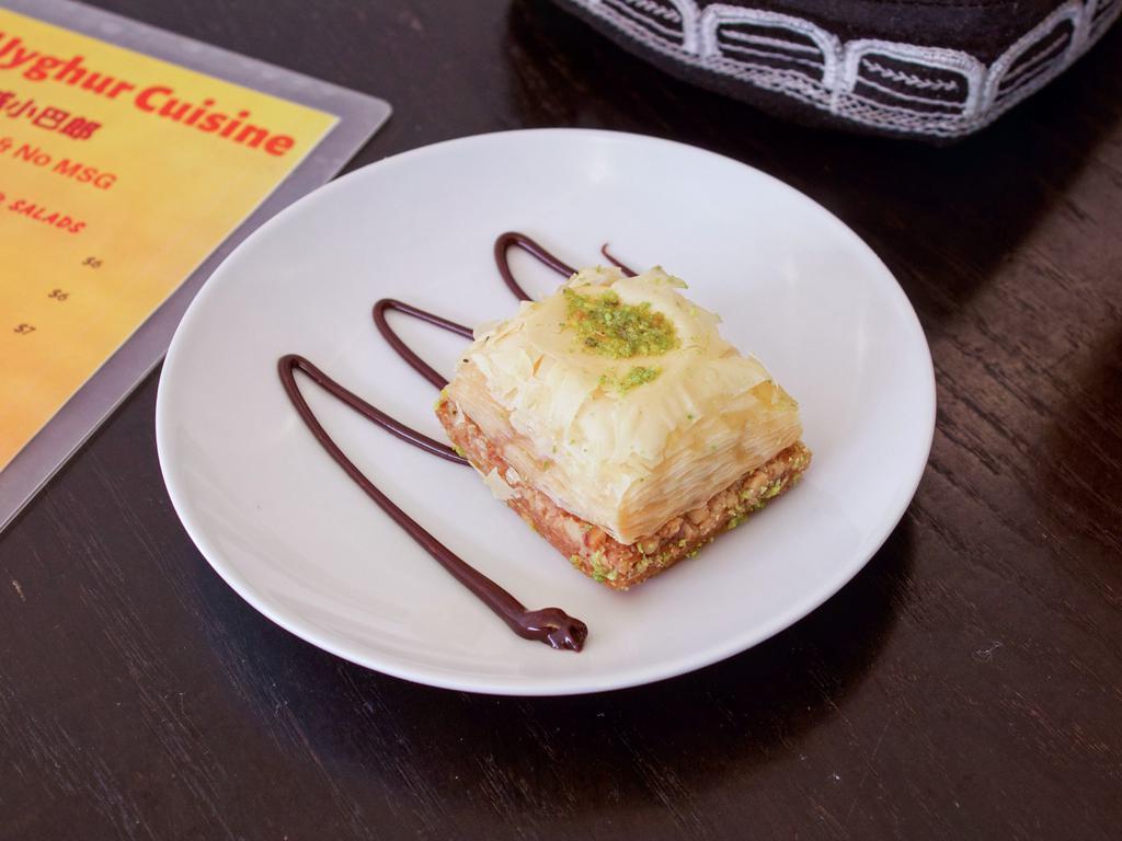 Baklava · Sweet dessert pastry made of layers of filo filled with chopped nuts and sweetened and held together with honey (Vegetarian)