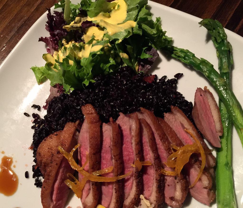 Pan-Roasted Duck Breast · Black rice w. Mandarin sauce and Asian vegetables.