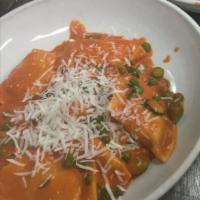 Ravioli di Granoturco alla Vodka Sauce  · Sweet corn and mozzarella ravioli, green peas, asparagus, and vodka sauce.