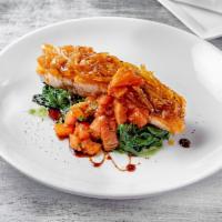 Salmone alle Cipolle · Baked salmon, caramelized onions crust, and sauteed spinach.