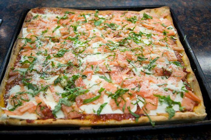 Fuhgeddaboudit Pizza · Grandma pie topped with fresh mozzarella cheese, diced tomatoes, chopped garlic and basil. 12 slices.