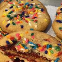 Black Cherry Rainbow cookie · Black cherry jam filled, rainbow sprinkles topped. Chewy and delicious.