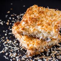 Coconut Magic Bar · Graham cracker crust, chocolate chips, walnuts and shredded coconut magically layered with s...