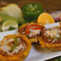 Tostones Relleno · Fried plantains topped with your choice of shrimp, ground beef, or chicken.