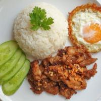 Garlic Chicken over Rice with Fried Egg (Pad Kra Tiem) · White meat chicken in a garlic and black pepper sauce, served over steamed jasmine white ric...
