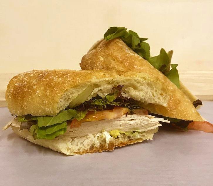 Chicken Avocado · Sliced grilled chicken, avocado and tomato with mesclun greens and creamy lemon mayonnaise on a fresh baked rustic baguette. [Allergens: Egg, Milk, Wheat] Handcrafted daily, no substitutions available. Dressing not available on the side. 