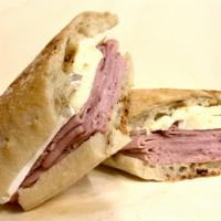Black Forest Ham and Brie · Black Forest Ham and Brie with whole grain honey mustard on a rustic baguette. [Allergens: W...
