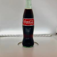 Mexican Soda · 12 oz Bottle of Mexican Coca Cola drinks. Mexican Coke is sweetened using cane sugar!