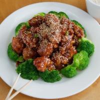 S4. Sesame Chicken · Chunks of chicken with brown sauce and broccoli with sesame seeds on top.