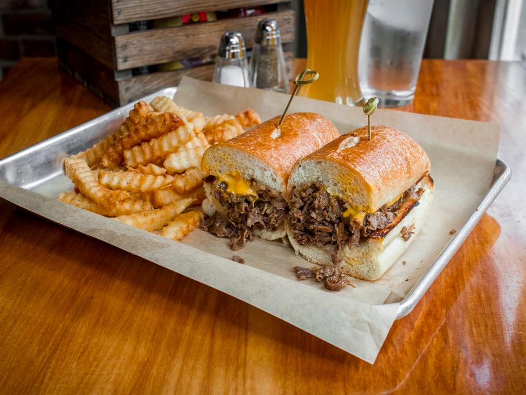 Philly Cheese Steak · Juicy slice steak with sauteed onions, fries. Choice of American, cheddar or zesty cheese sauce.