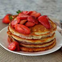 Strawberry Stack · 3 pancakes topped with freshly cut strawberries and whipped cream.