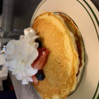 All American Stack · 3 pancakes layered with strawberries, blueberries and whipped cream.