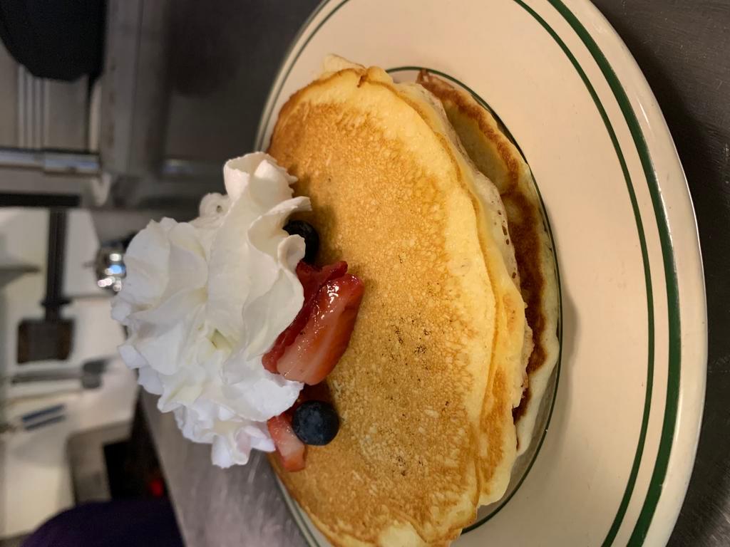 All American Stack · 3 pancakes layered with strawberries, blueberries and whipped cream.