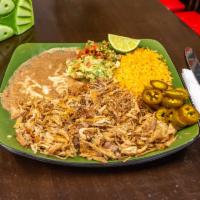 Carnitas de Puerco · Fresh pork carnitas stewed with bell peppers, onion, and served with rice, beans and fresh m...