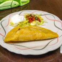 Puerquito Empanada · Fried pastry stuffed with carnitas and mozzarella cheese.