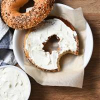 Bagel with Cream Cheese · Freshly baked bagel with a side of cream cheese.