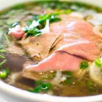 P1. Classic Rare Beef Pho Noodle Soup 生牛肉越南河粉 · Rare Beef  with rice noodles, served with beef broth, onions, scallions, and lemon, basil & ...