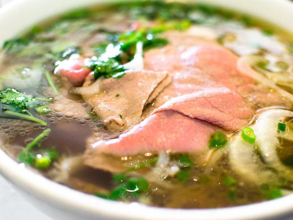 P1. Classic Rare Beef Pho Noodle Soup 生牛肉越南河粉 · Rare Beef  with rice noodles, served with beef broth, onions, scallions, and lemon, basil & bean sprouts on the side.