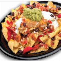Seasoned Beef Nachos Grande · Corn tortilla chips topped with cheddar and pepper jack cheese, homemade salsa fresca, refri...