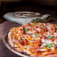 Tandoori Chicken Pizza · Tandoori chicken marinated in Pegasus special sauce and topped with mozzarella cheese, onion...