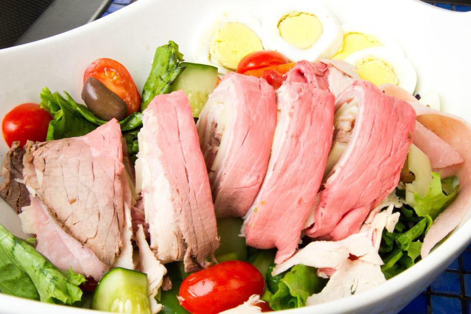 Chef Salad · Mixed greens, romaine lettuce, tomato, cucumber, Swiss cheese, ham, boiled egg, roast beef and roast turkey.