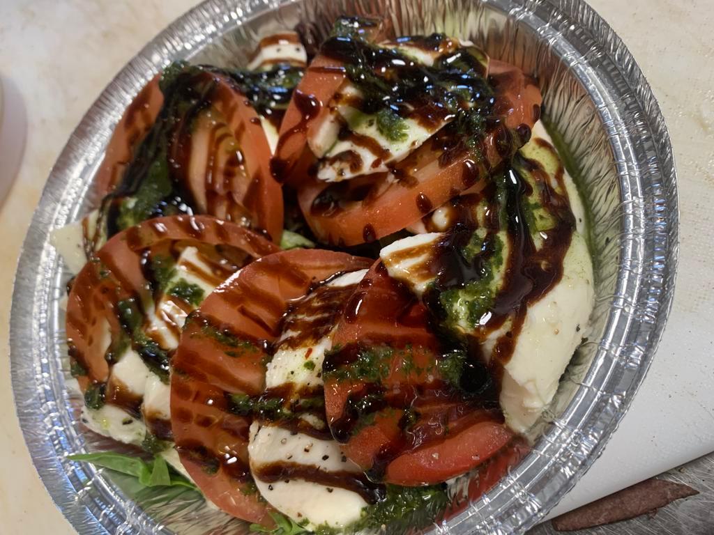 Caprese Salad · Light bed of Spring Mix topped with Tomato Slices, Fresh Mozzarella, Basil Oil & Balsamic Glaze