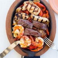 52. Fajita Combo · Combination of shrimp, chicken and CAB marinated skirt steak strips on a bed of sauteed onio...