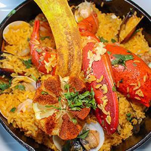 32. Paella en Casuela · Lobster tail, shrimp, chorizo, scallops, clams and mussels, sauteed in a white wine garlic sauce and tossed with saffron rice.