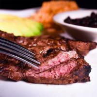 44. Mexican Faldita · CAB grilled skirt steak strips. Served with black beans, topped with queso fresco, rice and ...