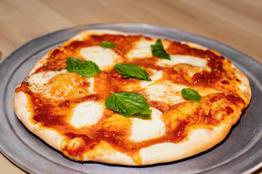 Margherita Pie · Tomato sauce, fresh garlic, oregano, fresh basil, mozzarella, Parmesan, olive oil.
