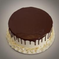 Tuxedo Cake · A moist layer of French vanilla cake with layer of fudgy chocolate brownie. Iced and filled ...