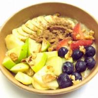 Oatmeal Supreme Breakfast · Oatmeal bowl topped with banana slices, strawberries, blueberries, sliced apples, walnuts, d...