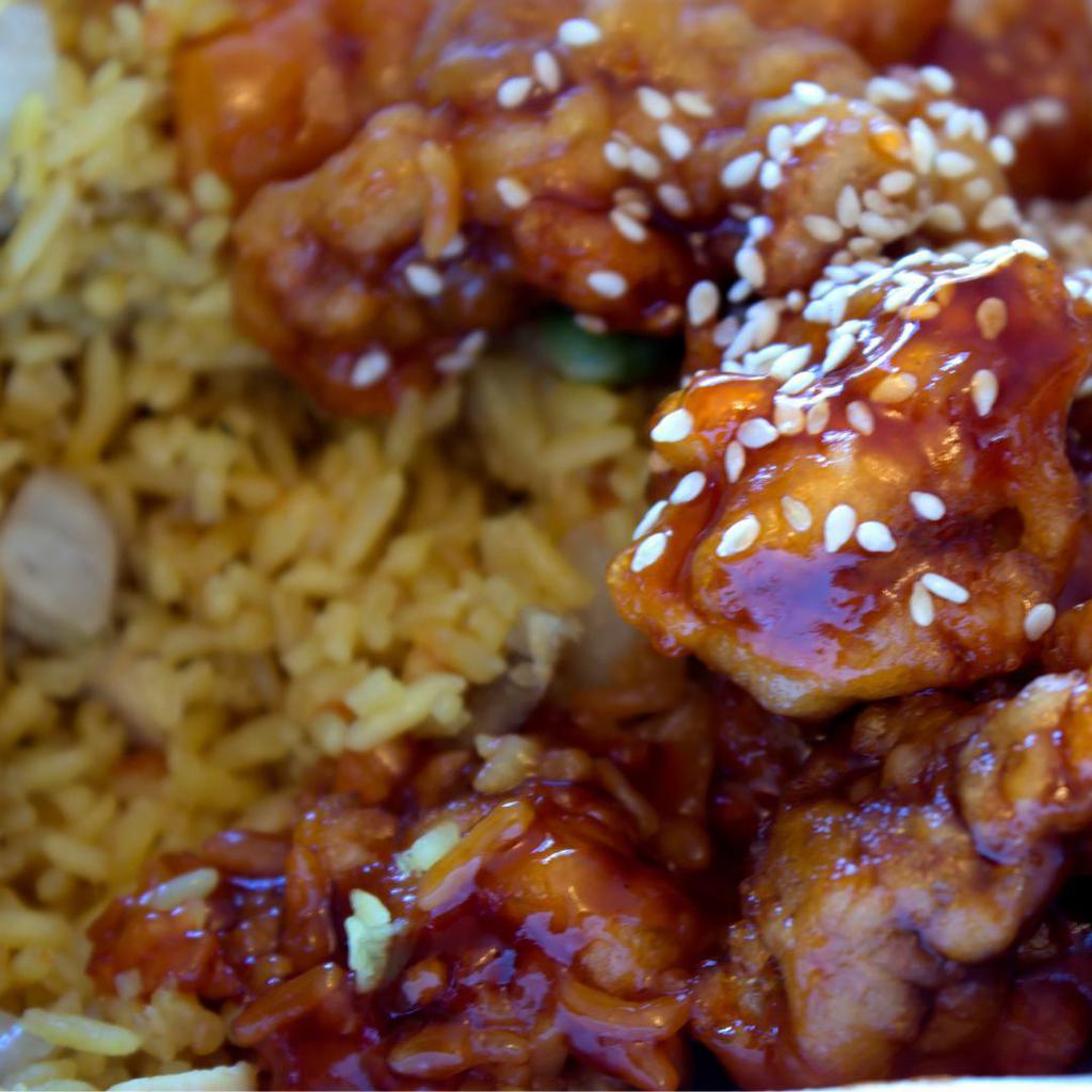 Sesame Chicken Bokkum Bap · Korean stir-fry rice with diced onions, carrots and scallion with oyster sauce or soy sauce, topped with sesame chicken.