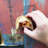 Bacon, Dates and Goat Cheese Empanada · Crispy applewood smoked bacon with thin sliced dates and goat cheese.