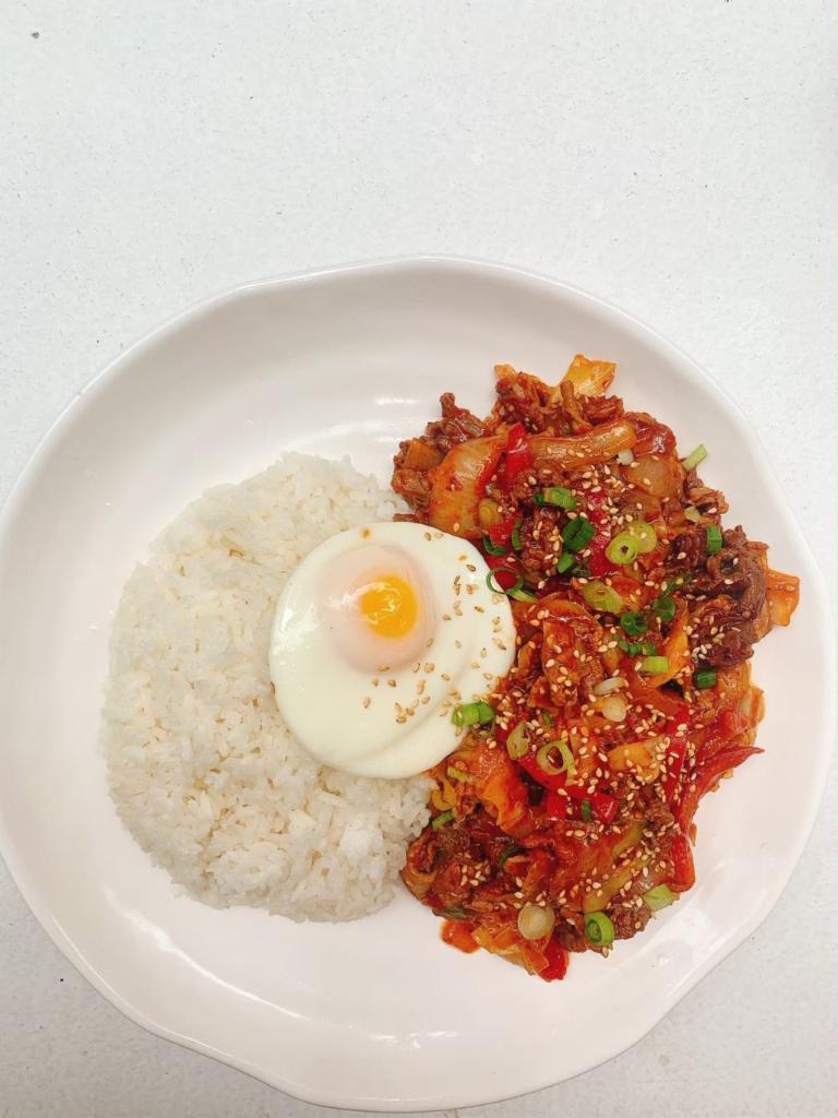 Spicy Pork & Bulgoki Over Rice · Pork and marinated beef stir fry over rice with fried egg on top.
spiciness level is adjustable.