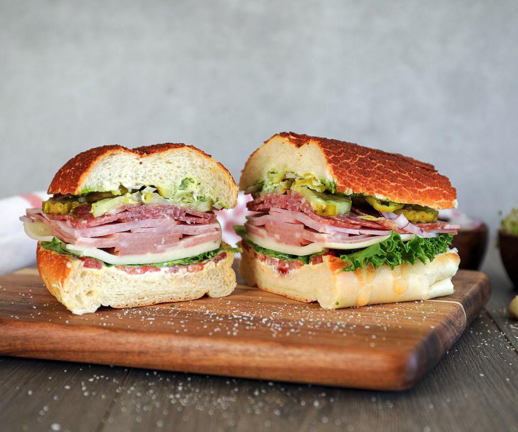 Premium quality Italian Soprano Sandwich  · Capicola, is a versatile and flavorful cold cut that brings a different layer of complexity to you breakfast or dinner sandwich. It is delicately spiced and slightly smoky. ( ham, salami, soppressata, capitola, pepperoni, prosciutto, provolone, hot/roasted peppers, lettuce, tomato, onion, mayo and vinegar)