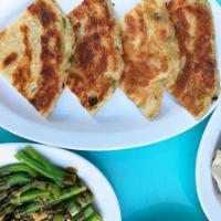 Scallion Pancake · Everyone's favorite. Flaky scallion pancake served with 4 pieces. Contains sesame seeds.