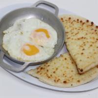 #9.  Huevos al Gusto · Servidos con arepa con queso. Eggs any style, served with corn cake topped with Colombian wh...