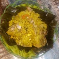 Tamal tolimense  · Stuffed with potatoes, pork, peas, chicken, egg and carrots,   in a plantain leaf with rice