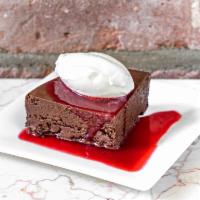 Flourless Chocolate Cake · Made with 70% Peruvian chocolate. Served with decadent raspberry  sauce, topped with fresh w...