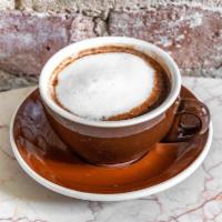 Cafe Torino · A cup of our 60% Dark  Hot Chocolate and a shot of espresso topped with a dollop of foam.  