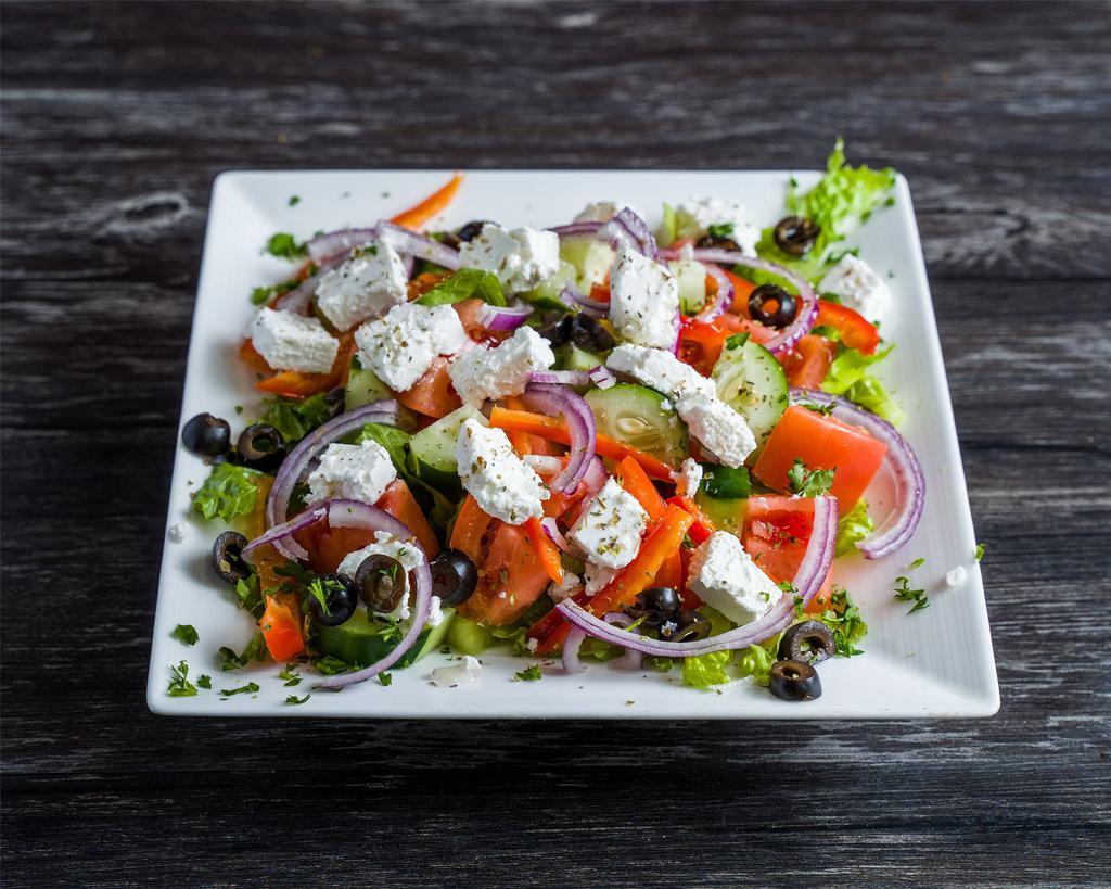 Greek Salad · Lettuce, tomatoes, cucumber, onions, black olives & greek feta cheese. Served with balsamic dressing