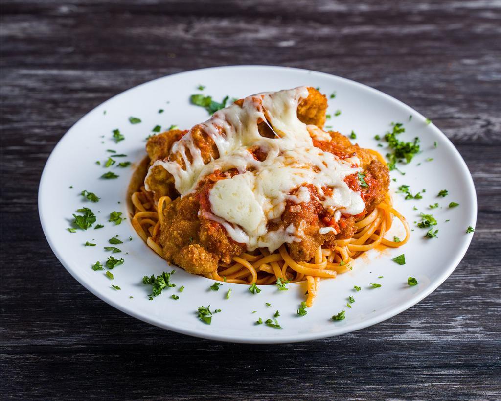 Chicken Parmigiana · Chicken breast with pasta of your choice in homemade tomato sauce baked with mozzarella cheese.