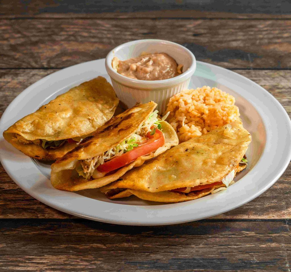 Fried Taco · 3 crispy taco filled with your choice of chicken, ground beef or shredded beef with salad and cheese on top, served with rice and beans.