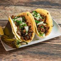 Taco de Barbacoa · 4 corn tortillas filled with homemade style barbacoa served with rice, beans, cilantro and f...