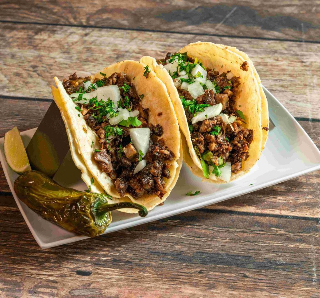 Taco de Barbacoa · 4 corn tortillas filled with homemade style barbacoa served with rice, beans, cilantro and fresh onions.