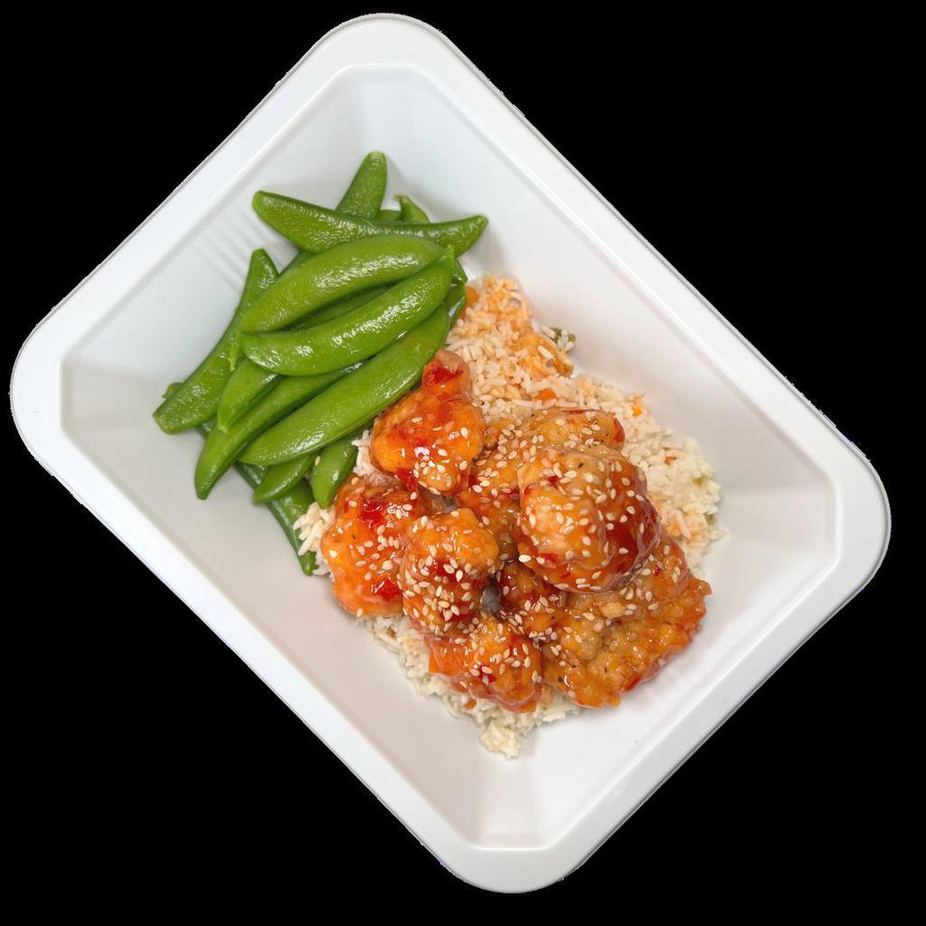 Sesame Chicken · Breaded chicken coated in sweet chili sauce and sesame seeds over white rice and snap peas.